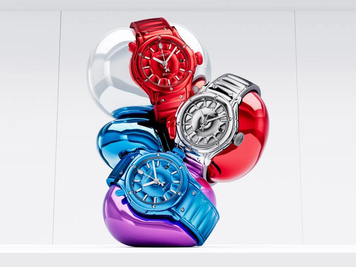 Red, silver and blue watches arranged with reflective balloon-like forms